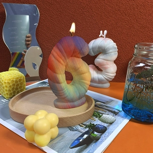 Number shaped DIY scented candles with matte texture on wooden tray for decor