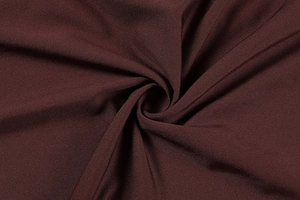 Close-up of deep burgundy fabric texture showing fine twill pattern and smooth finish