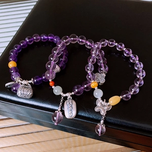 Detail view of S925 silver amethyst and Hetian jade beaded bracelets on a black box