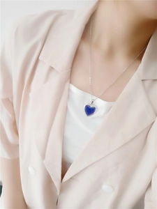 Close-up of a color-changing heart pendant necklace worn on a model's neck