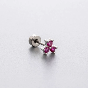 Silver titanium steel clover stud earring with three round red zircons on grey background