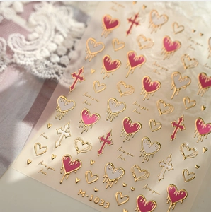 Detail of M-1033 3D nail stickers with golden embossed hearts and crosses motifs