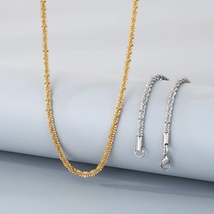 Detail of twisted rope chains in gold and silver finishes made of durable titanium steel