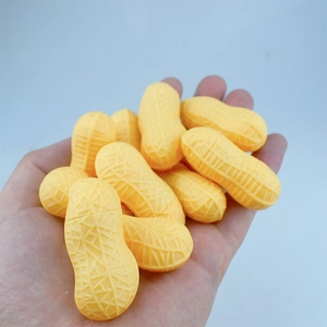 Detailed macro shot of peanut-shaped toys showing realistic shell texture and yellow color