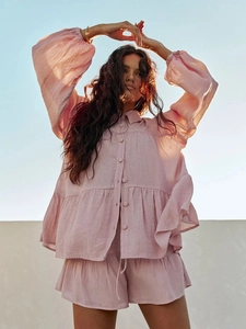 Detailed view of pink cotton linen set featuring ruffle hem shirt and matching shorts