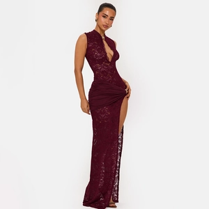 Detail of burgundy lace dress with cutout neckline, waist ruching and high leg slit