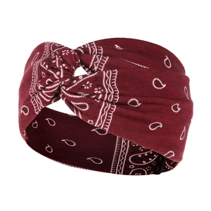 Close-up of wine red paisley pattern yoga headband with knotted cotton fabric texture