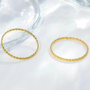 Elegant gold twisted rope ring set in titanium steel shown from a 45-degree angle view