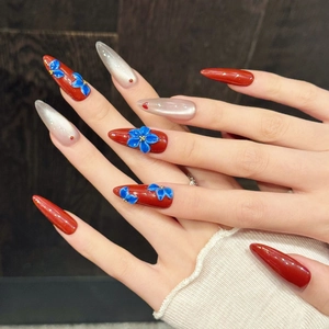 Handmade stiletto press-on nails with 3D blue flowers and red cat eye design
