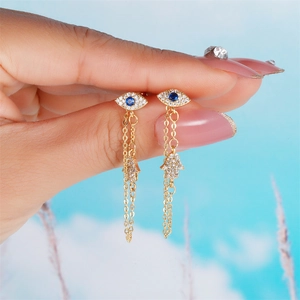 Gold Evil Eye and Hand of Fatima long chain drop earrings with blue zircon crystals