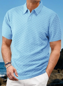 Close-up of sky blue knit polo shirt with detailed herringbone jacquard texture