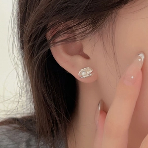 Elegant 925 sterling silver shell stud earrings with white pearl detail on model