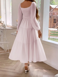Detail view of pink long sleeve tiered dress with tiered skirt and pleated texture