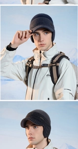 Close-up of winter knit trapper hats with ear flaps and visors for outdoor hiking
