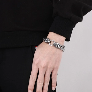 Macro detail of punk double snake head bracelet in vintage silver finish on wrist