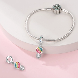 Detail of silver snake chain bracelet with colorful lollipop charms and green floral clasp