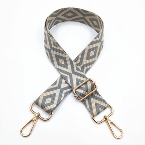 Close-up of wide canvas shoulder strap with embroidered grey rhombus geometric pattern