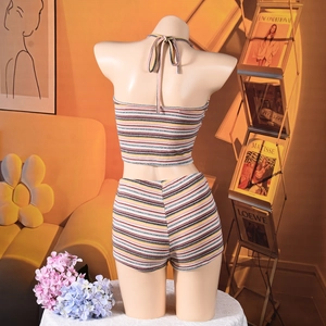 Close-up of the backless halter top and matching knit shorts with multi-color stripes
