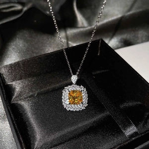 Detailed macro of a square yellow gemstone necklace pendant in a luxury jewelry gift box