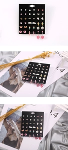 Close-up of kids colorful earring set with donut and unicorn shapes on display card