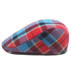 Detailed view of the red and blue plaid tartan fabric texture on the flat cap