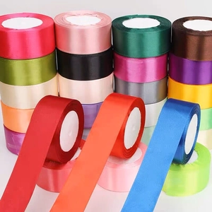 Vibrant 4cm satin ribbons in multiple colors stacked for DIY gift wrapping and wedding decor