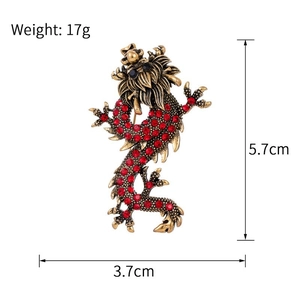 Detailed view of vintage gold dragon brooch with red rhinestones and measurements