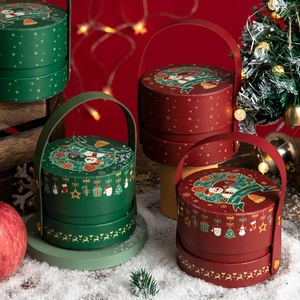Christmas gift boxes in green and red with leather handles and Merry Christmas prints