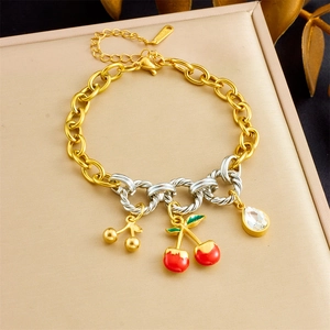 Detail of a stainless steel bracelet featuring red enamel cherry charms and zircon