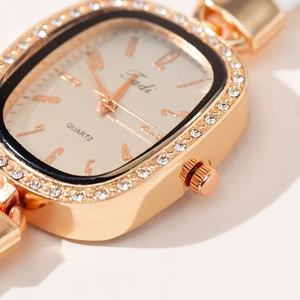 Women's rose gold square watch with crystal-encrusted bezel and metallic strap
