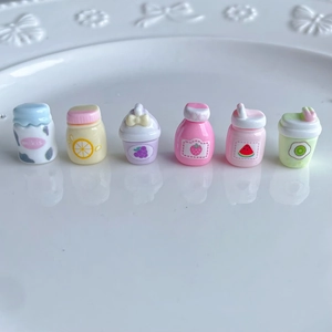Detailed view of six miniature resin juice bottles in assorted macaron pastel colors