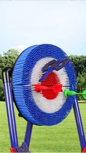Outdoor matrix dart target with plastic bristles, axe throwing toys and stand on green grass