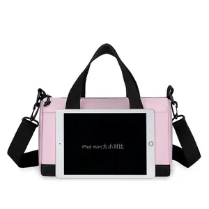 Pink nylon crossbody pillow bag with adjustable strap and iPad mini size reference