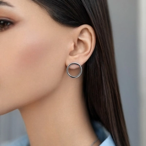 Silver geometric hoop earrings shown on a model highlighting minimalist design