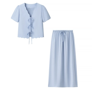 Flat lay of sky blue two-piece set featuring short sleeve tie-up top and long skirt