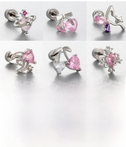 Detailed views of pink cherry heart and planet zirconia earrings with screw back studs