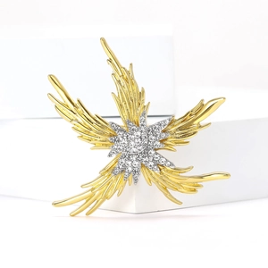 Elegant gold starfish brooch with feathered texture and sparkling white crystals on a white stand