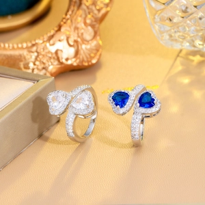 Macro detail of silver rings featuring blue and white heart-shaped sapphire stones
