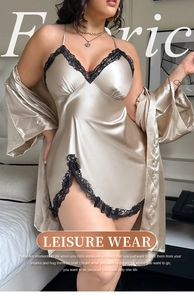 Detail of champagne satin nightgown featuring delicate black lace trim on the V-neckline