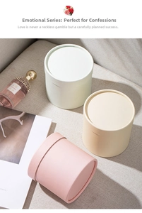 Detailed view of mini round cardboard flower boxes in pink, beige, and light green matte finish