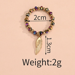 Detailed view of elastic beaded ring featuring golden charms and 2cm inner diameter
