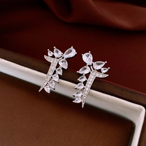 Detailed view of leaf-shaped earrings with pear-cut cubic zirconia on a red box