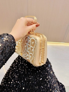 Detail of luxury champagne gold evening bag featuring hand-set pearls and rhinestones