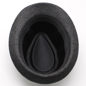 Overhead view of a black woven straw fedora hat with sweatband on white background