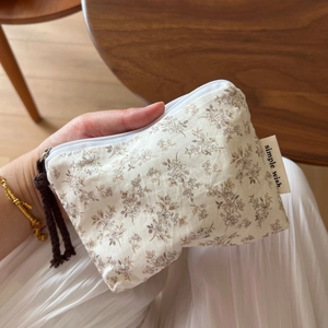 Detail of floral cotton mini pouch with zipper closure and hemp rope pull handle