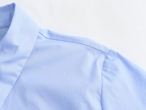 Detail shot of blue poplin shirt collar showing neat stitching and high-quality fabric