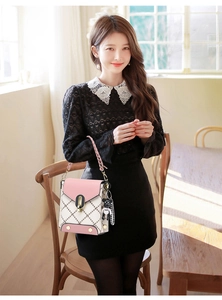Pink and white quilted crossbody bag with cute bear charm held by a woman in a black dress