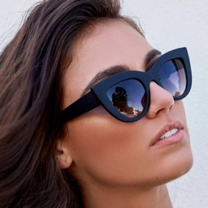 Women's vintage black cat-eye sunglasses with thick frame and dark gradient lenses