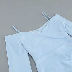 Detail view of the light blue mini dress featuring cross-strap shoulders and a V-neckline