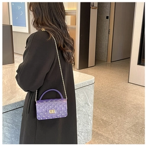 Quilted clear purple jelly bag with gold chain strap worn by model in chic black outfit